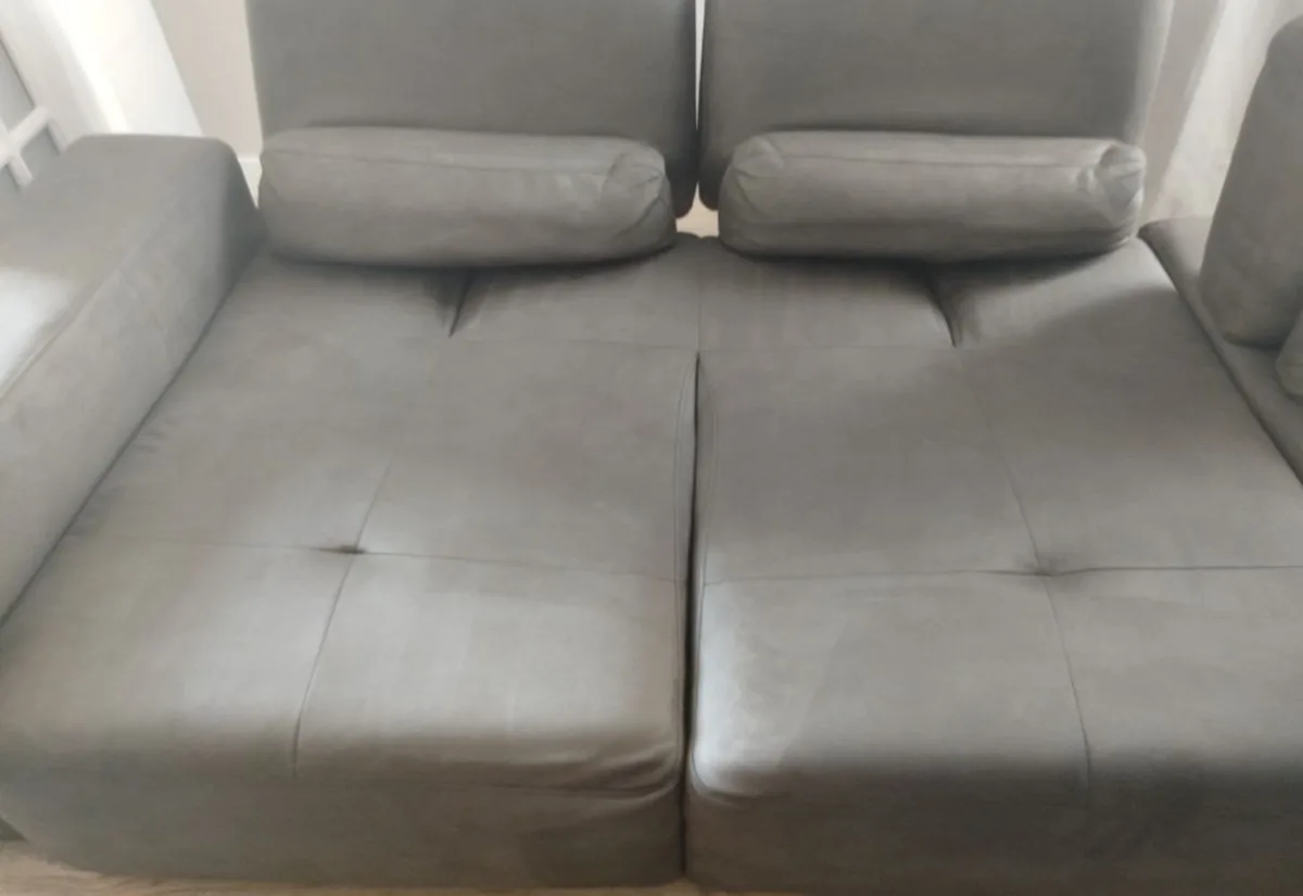 Grey suede sofa after a steam clean &mdash; even, matte grey across both seat cushions.